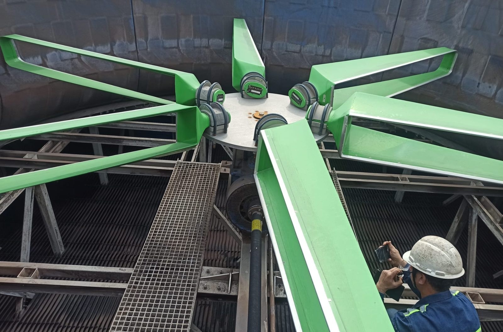 Worker photographing a six-blade GT Green Fan from the fan deck